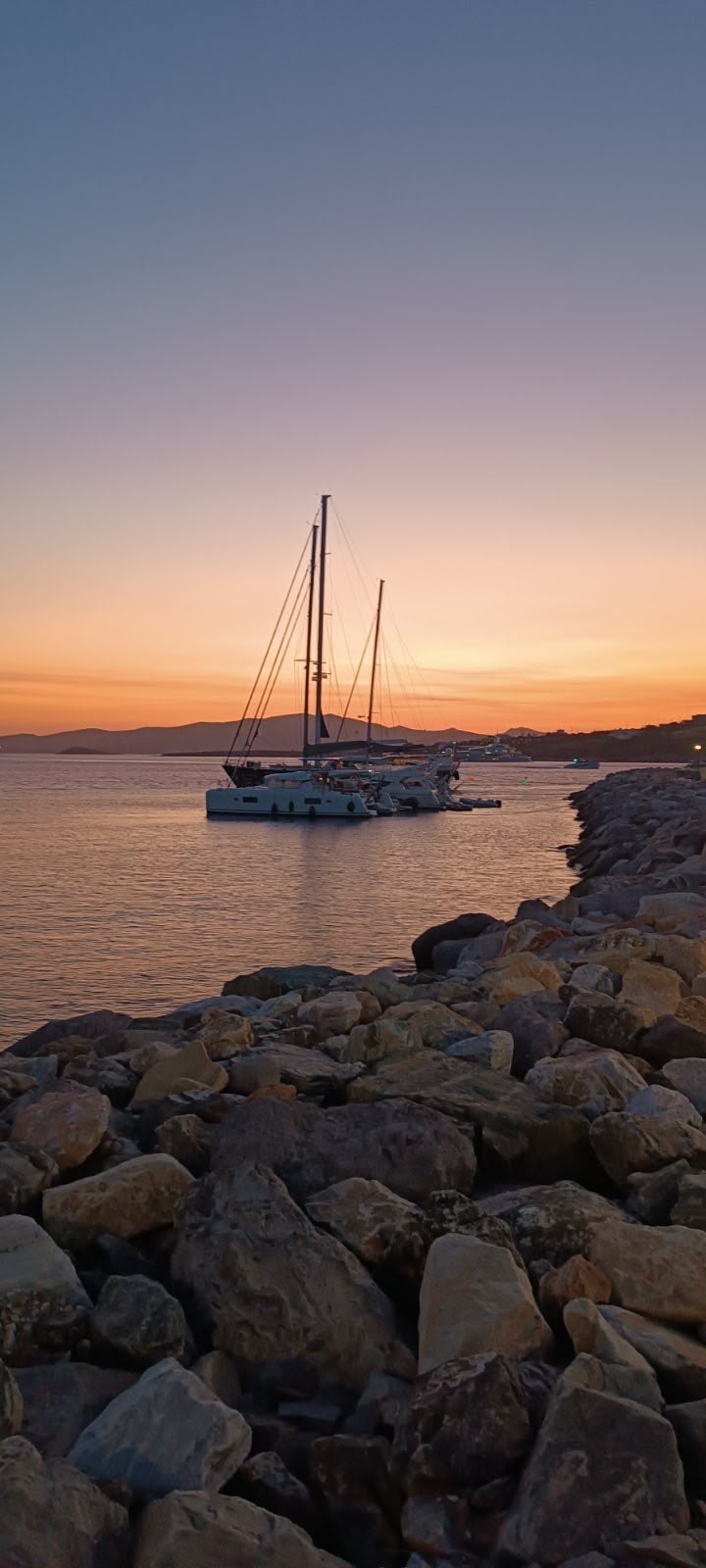 Sailing boats at sunset in Paros